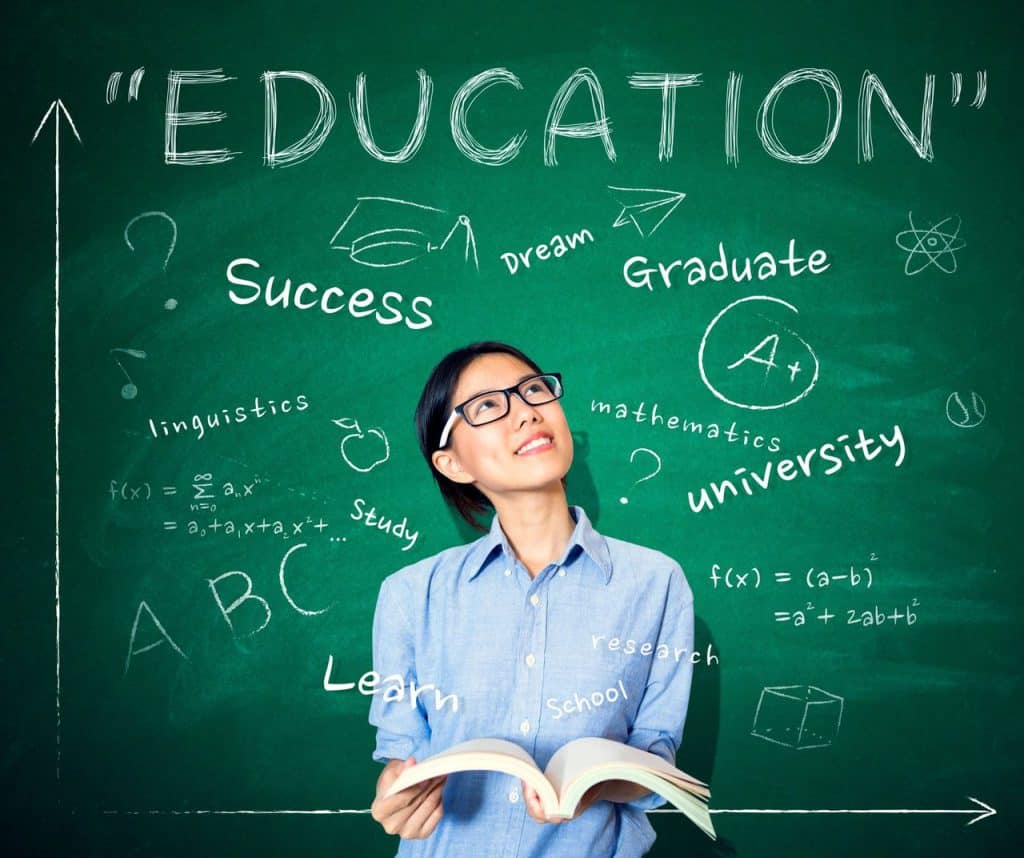 woman in front of chalkboard